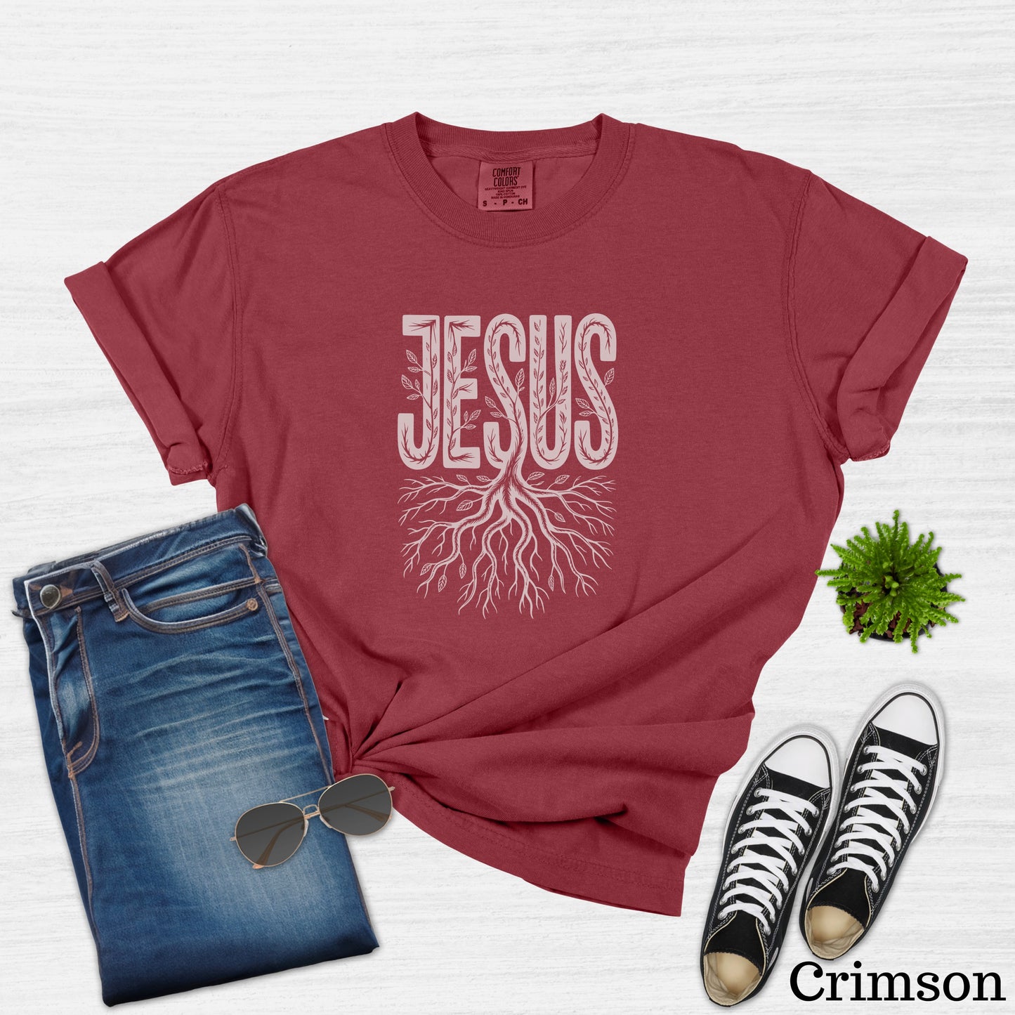 Crimson t-shirt with "JESUS" in white text and a tree root design.