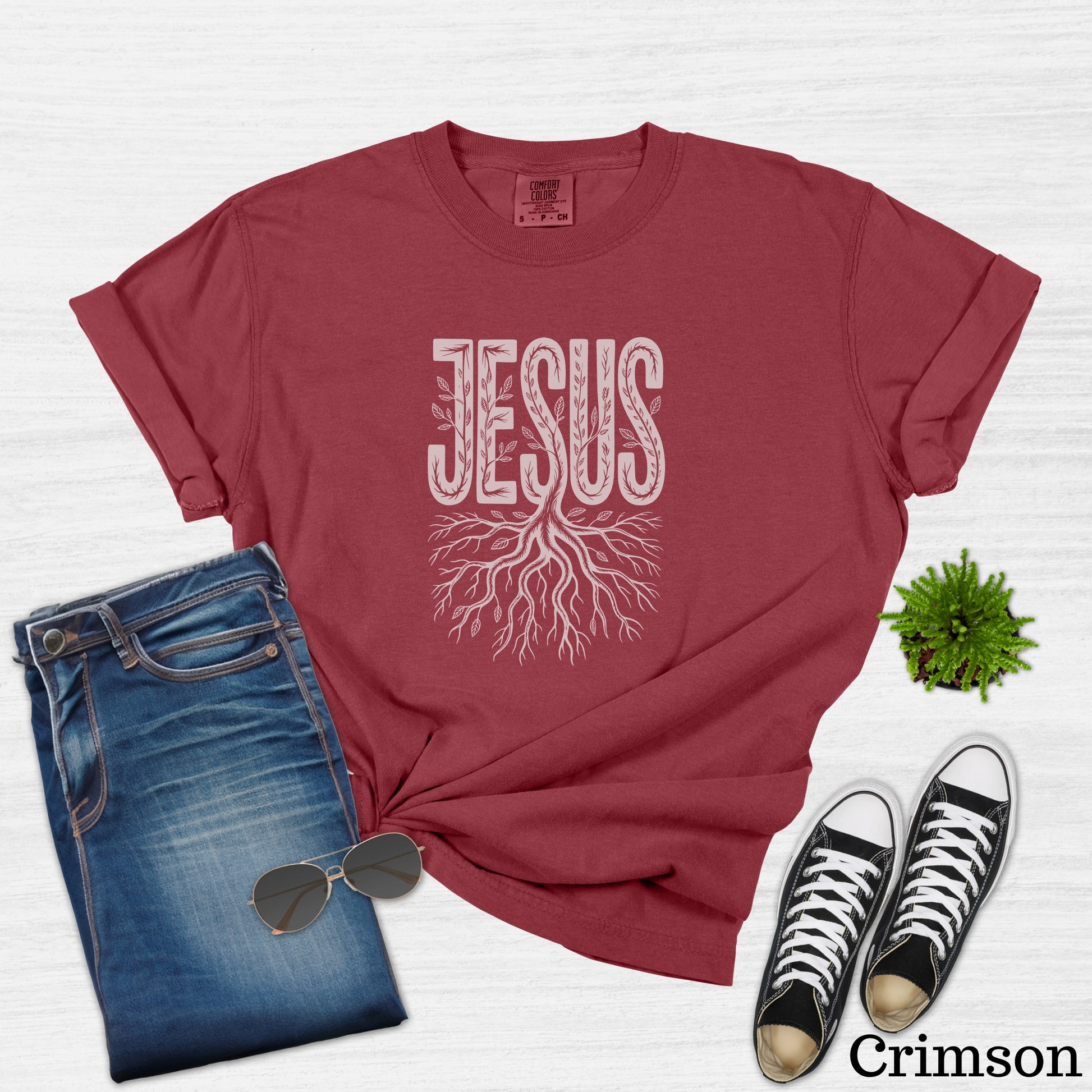 Crimson t-shirt with "JESUS" in white text and a tree root design.