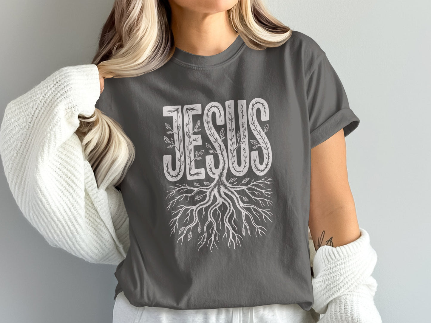 Dark grey t-shirt with "JESUS" text and tree roots design.