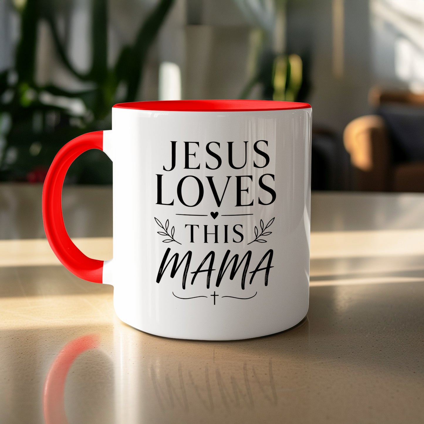 White mug with red handle, "Jesus Loves This Mama" text and cross.