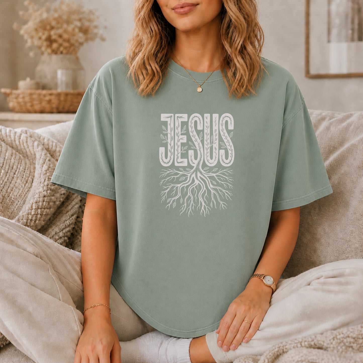 Green t-shirt with white "JESUS" text and root design.