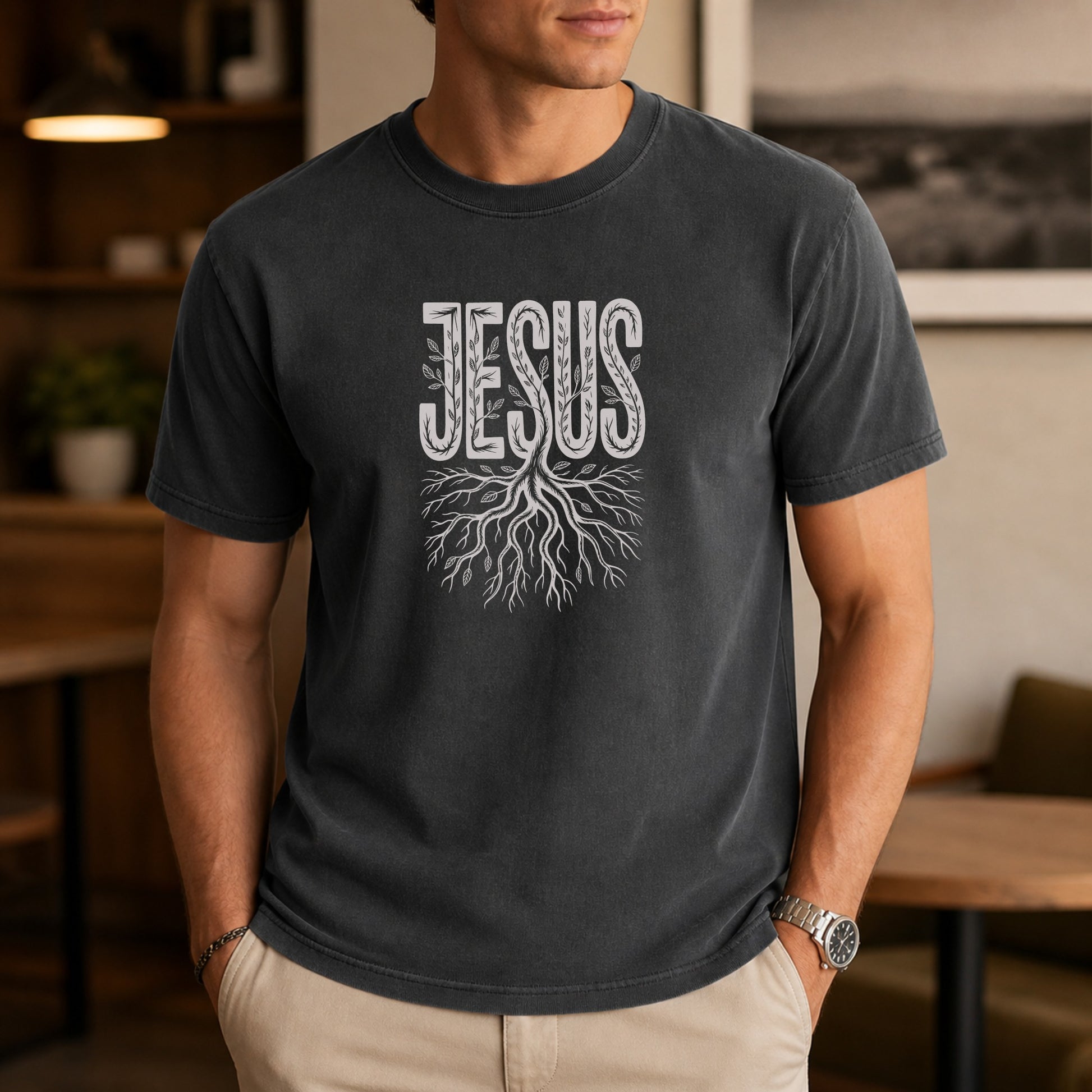 Dark t-shirt with "JESUS" text above a tree root design.