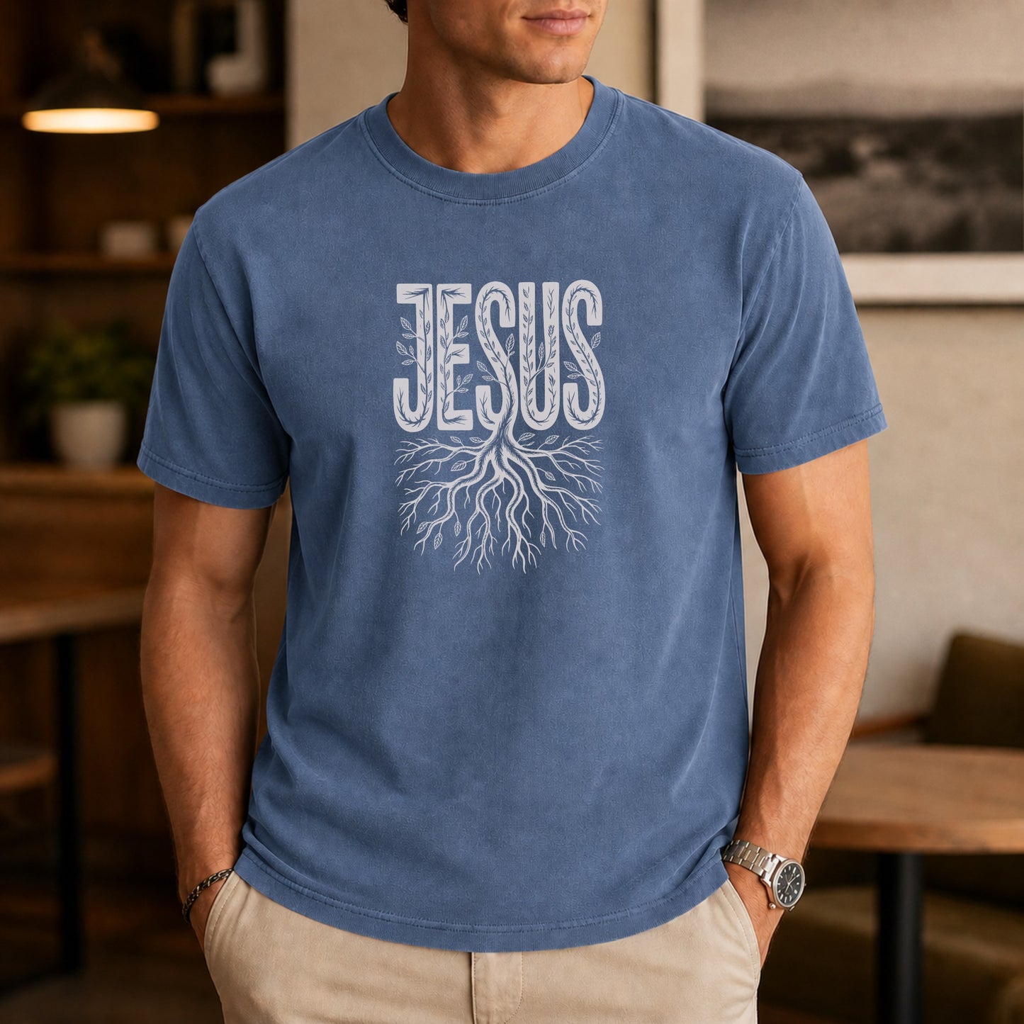 Blue t-shirt with "JESUS" text above a tree root design.