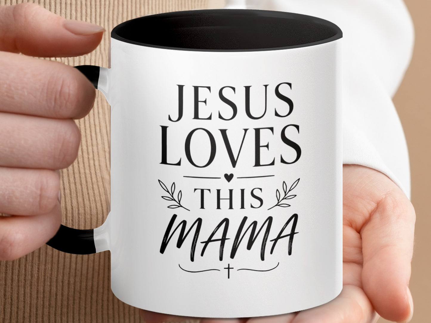 White mug with black rim and handle, "Jesus Loves This Mama" text.