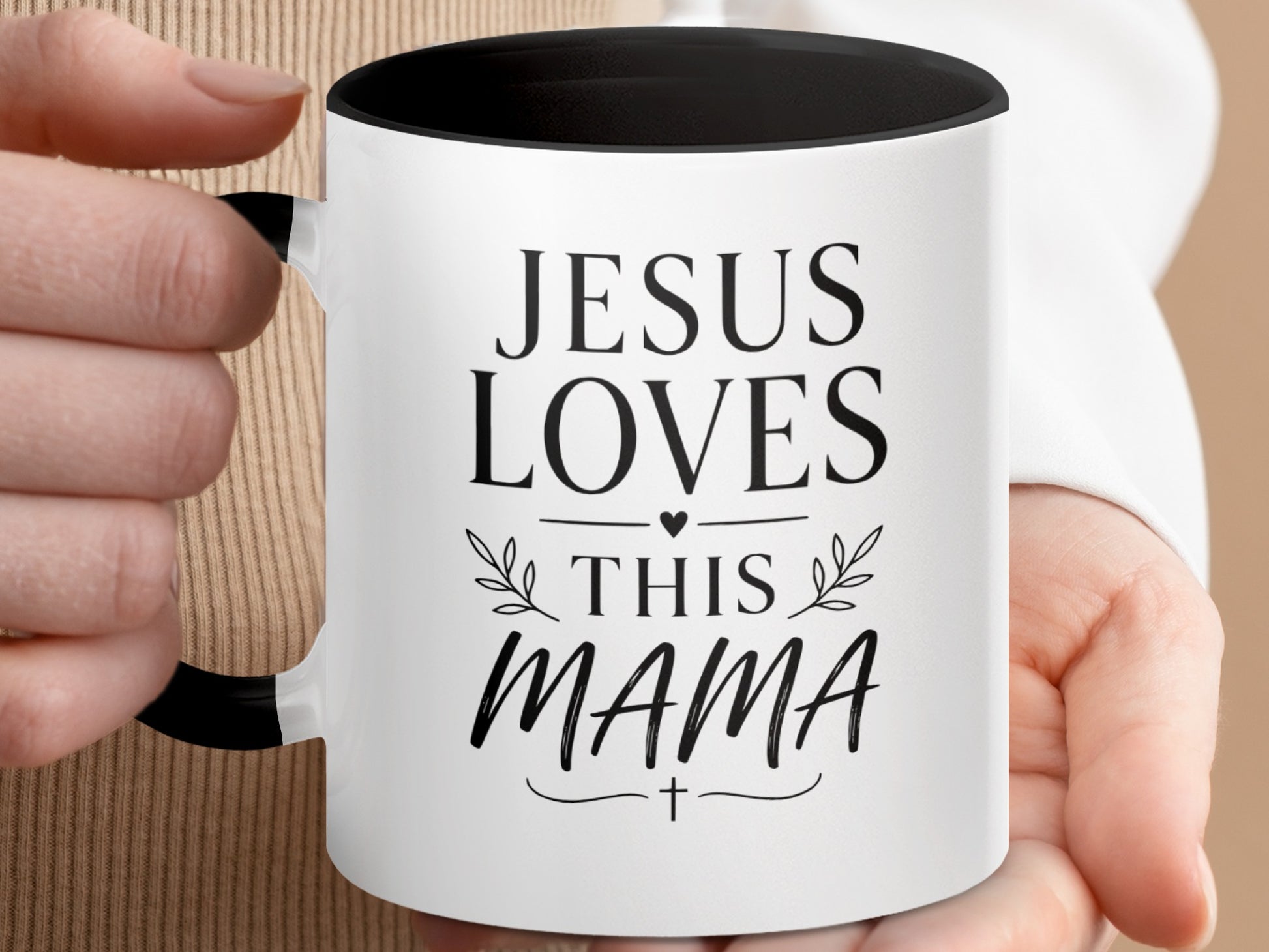 White mug with black rim and handle, "Jesus Loves This Mama" text.