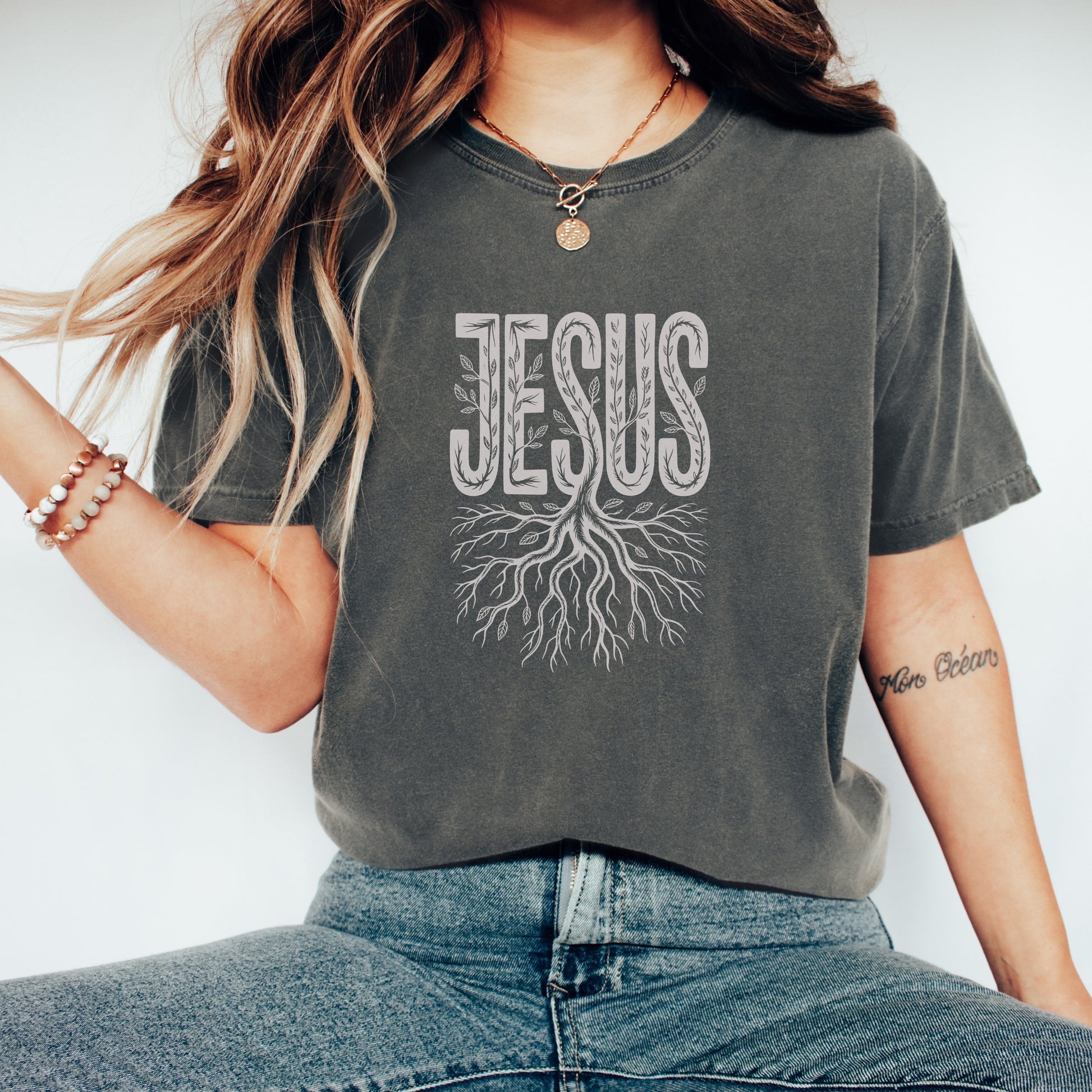T-shirt with "Jesus" text in a tree root design.