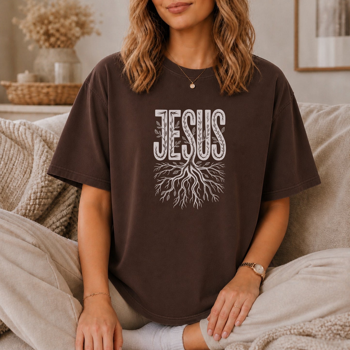 Brown t-shirt with white "JESUS" text and root design.